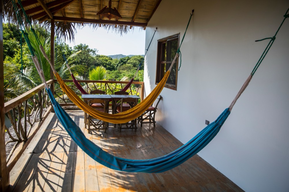 A shaded tropical terrace with rattan furniture